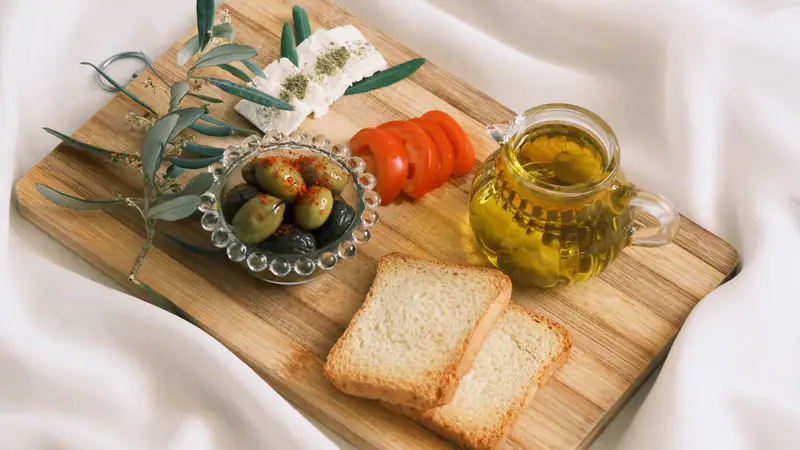A meze board with cheeses, olives and oil