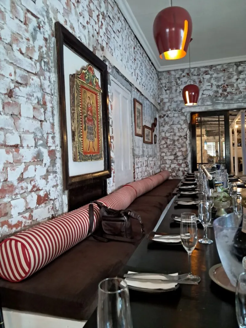 The long dining room with whitewashed brick