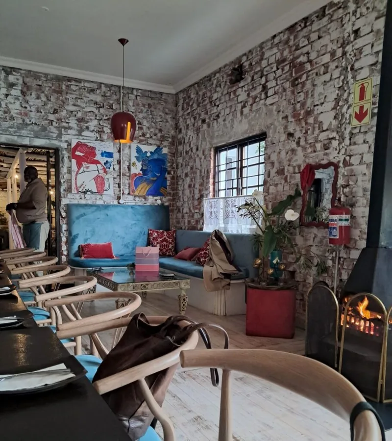 The lounge with a fireplace and brick walls