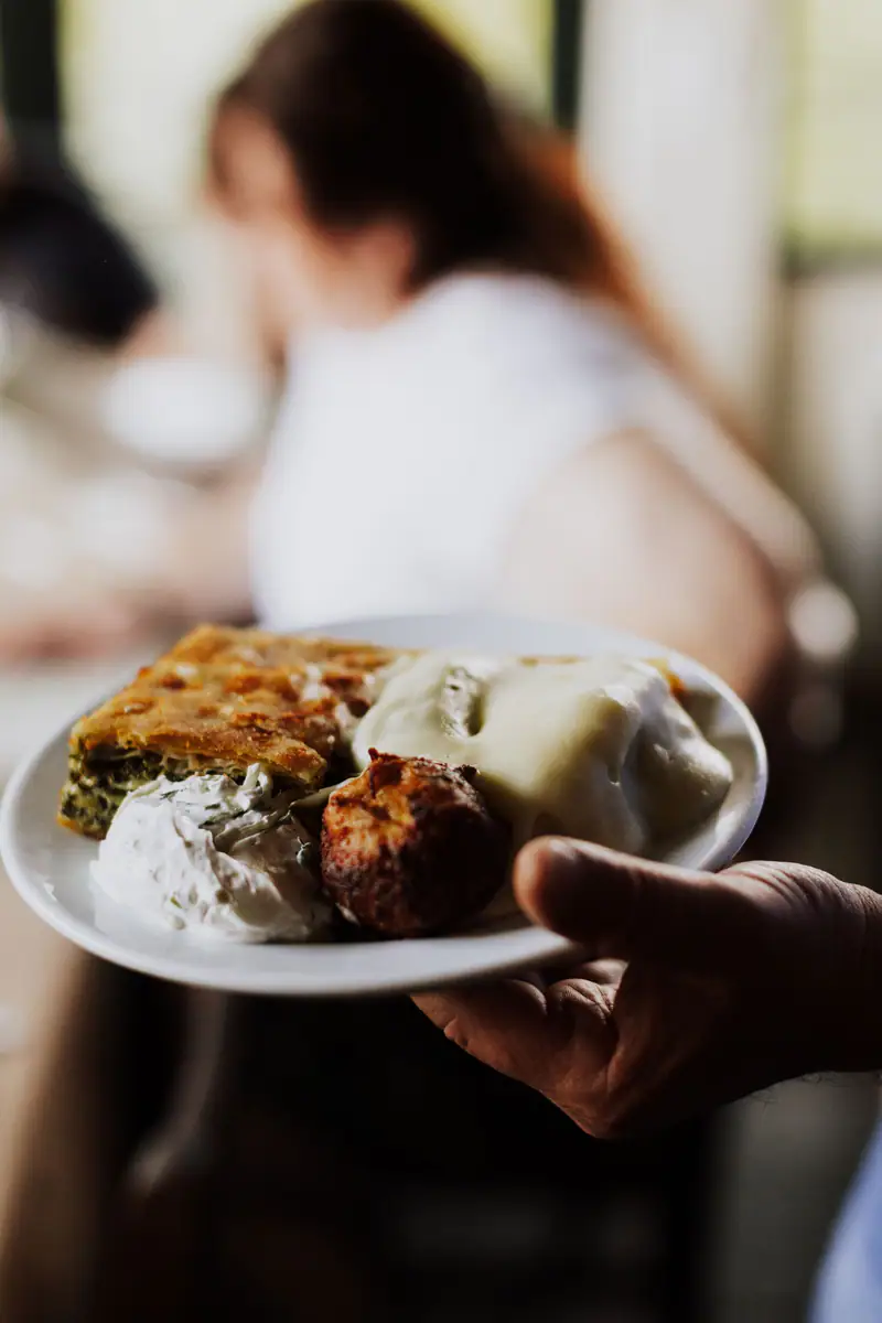 A waiter serving a plate of food