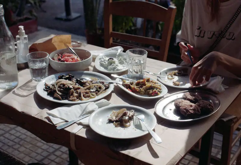 A long table of shared plates after a feast