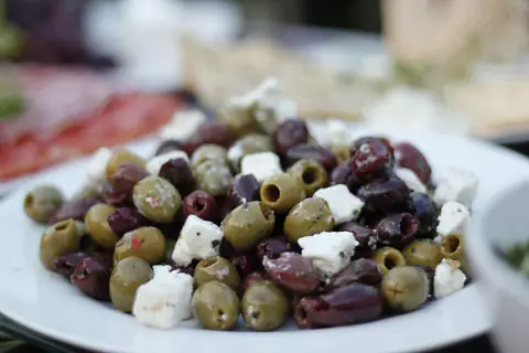 A bowl of olives with feta