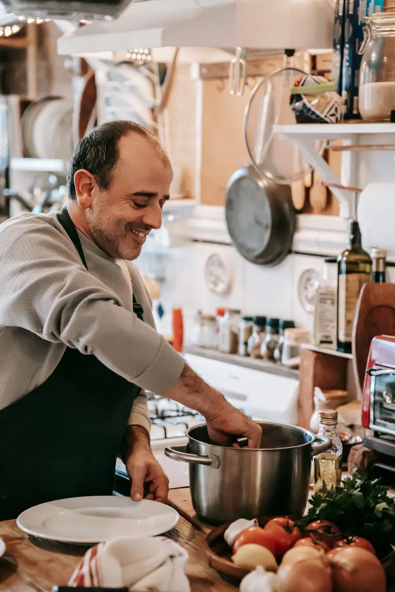 Chef Nikos plating food in the kitchen