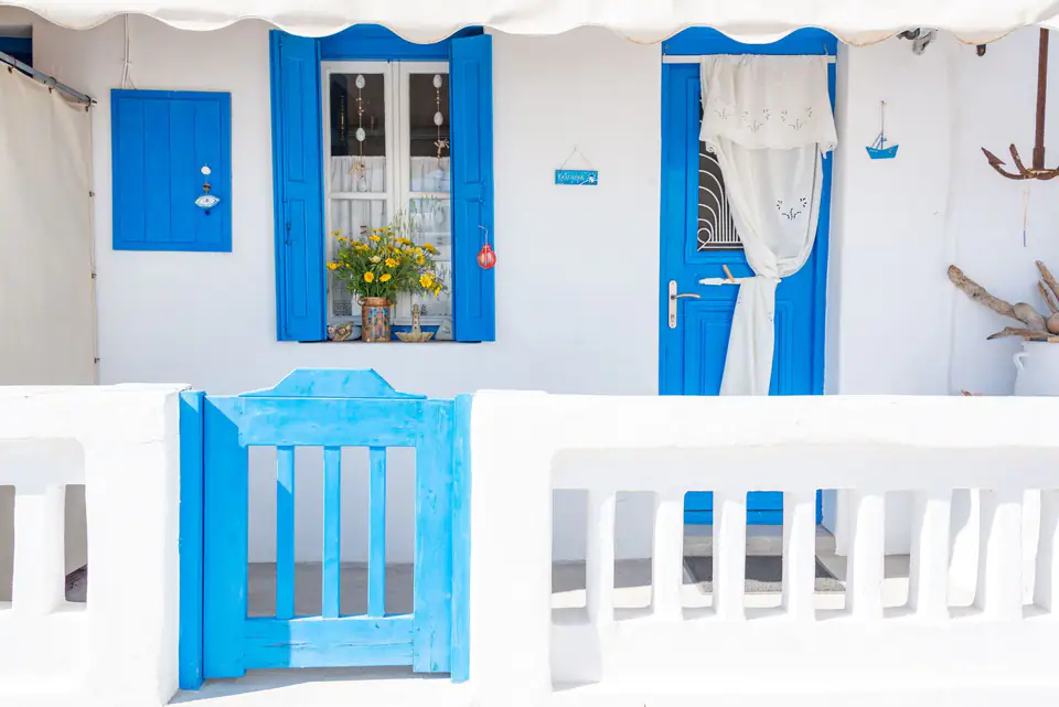 Whitewashed houses above a blue sea